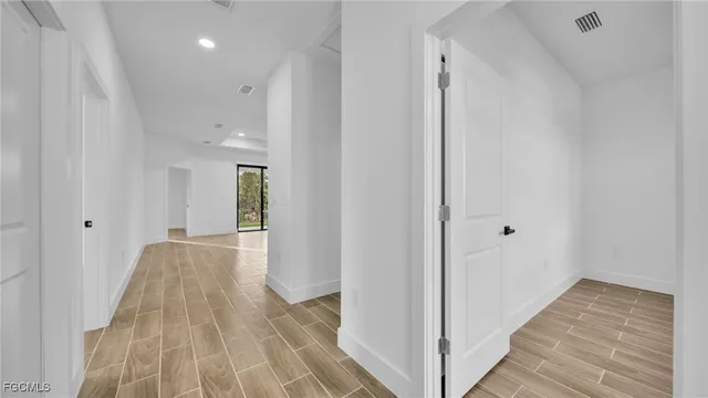 a view of hallway with wooden floor