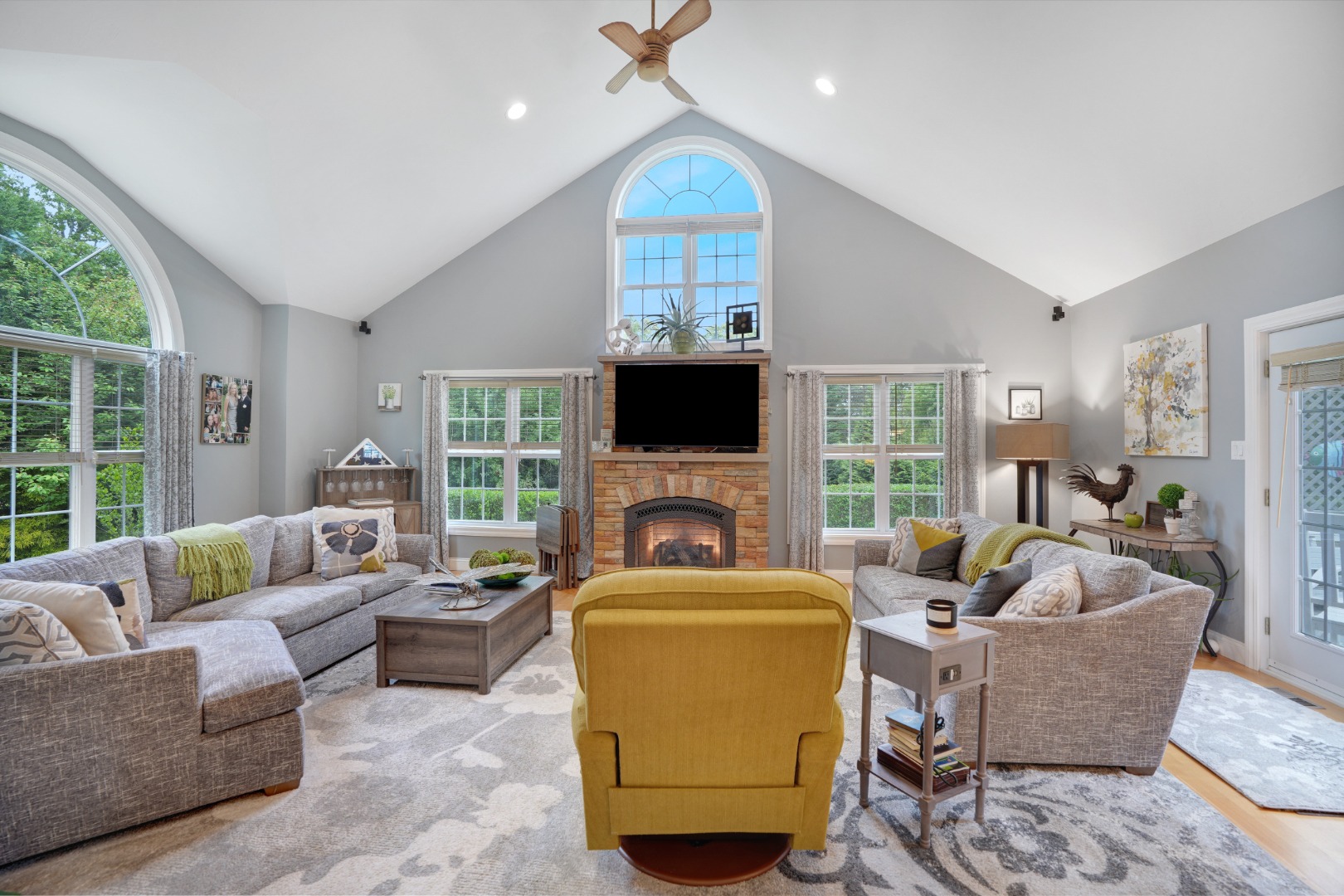 8 Fresh Pond Road Oak Bluffs, MA 02557 - Photo 8 of 36 a living room with furniture a fireplace and a flat screen tv