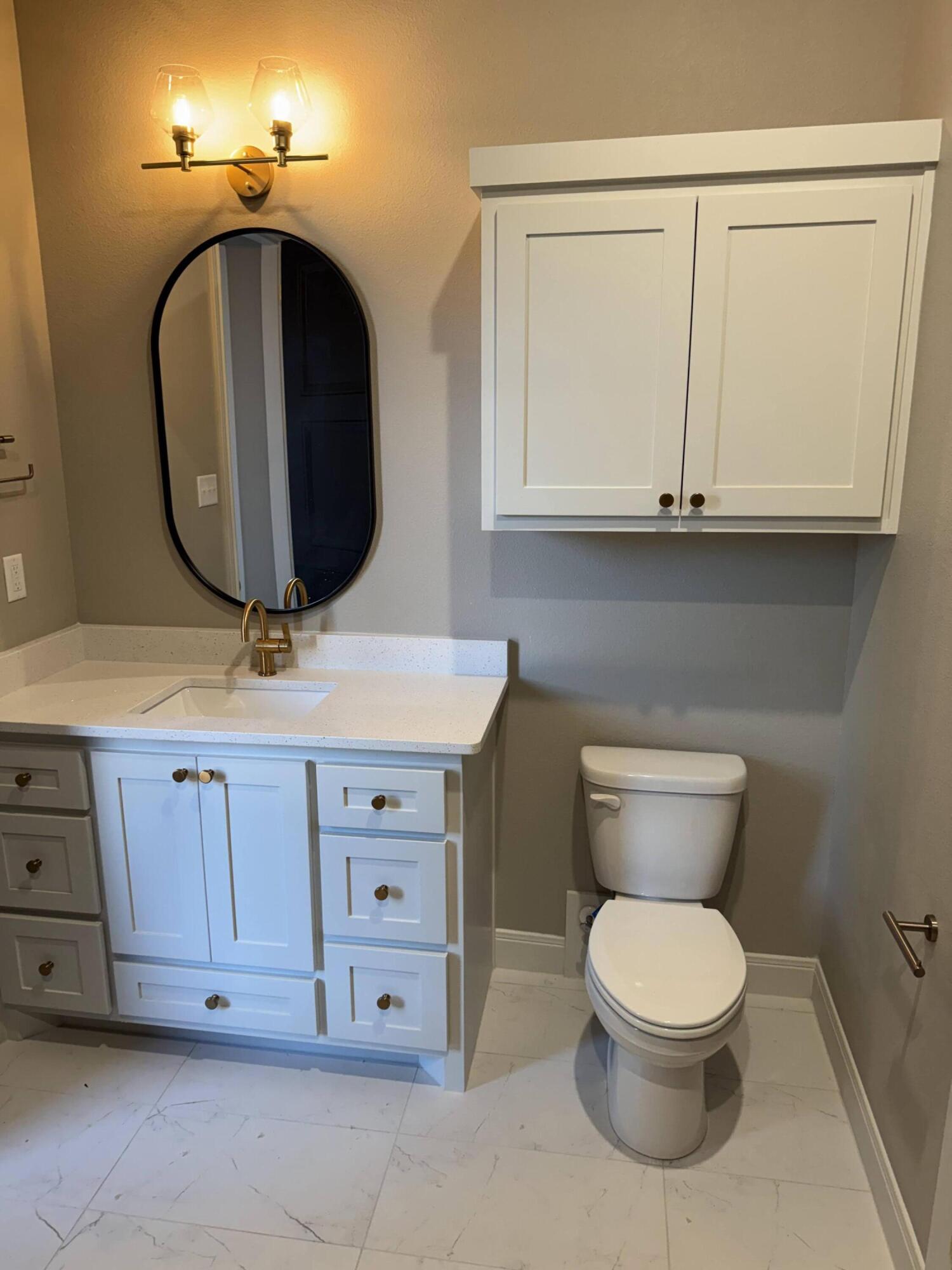 309 Maple New Home, TX 79381 - Photo 19 of 27 a bathroom with a toilet a sink and mirror