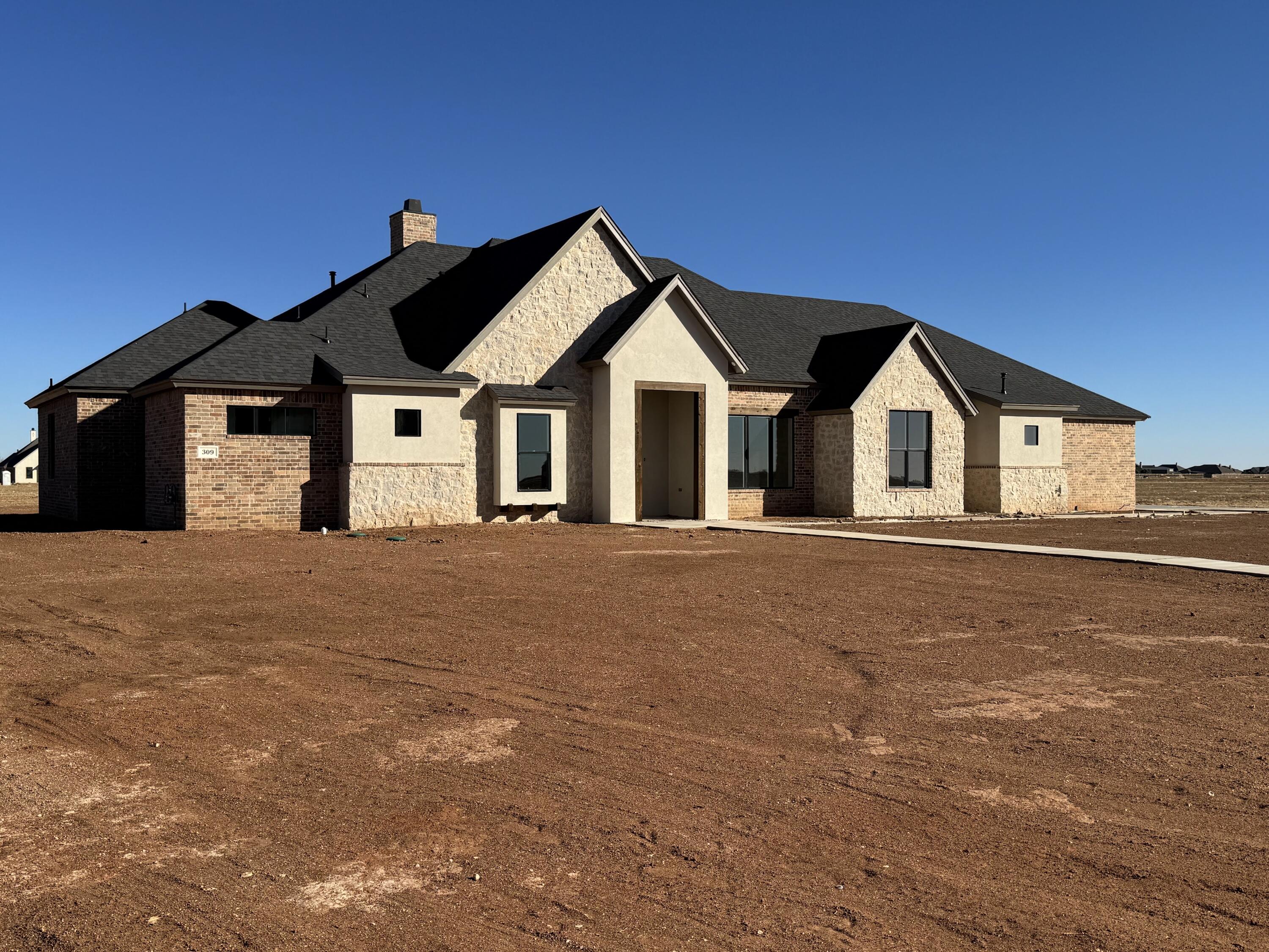 309 Maple New Home, TX 79381 - Photo 2 of 27 a front view of a house with a yard