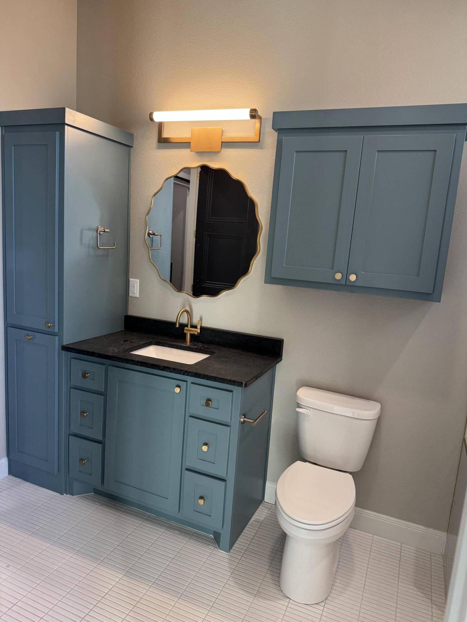 309 Maple New Home, TX 79381 - Photo 21 of 27 a bathroom with a toilet sink and mirror