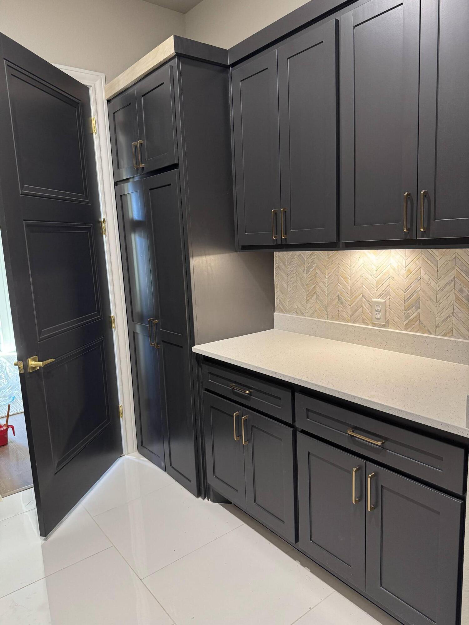 309 Maple New Home, TX 79381 - Photo 24 of 27 a kitchen with a sink and refrigerator