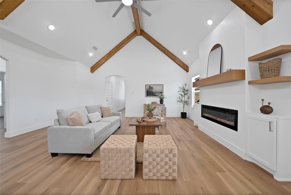 801 Tierney Road Fort Worth, TX 76112 - Photo 9 of 30 Vaulted ceiling with exposed wood beams, wood-finish flooring, built-in electric fireplace, and recessed lighting