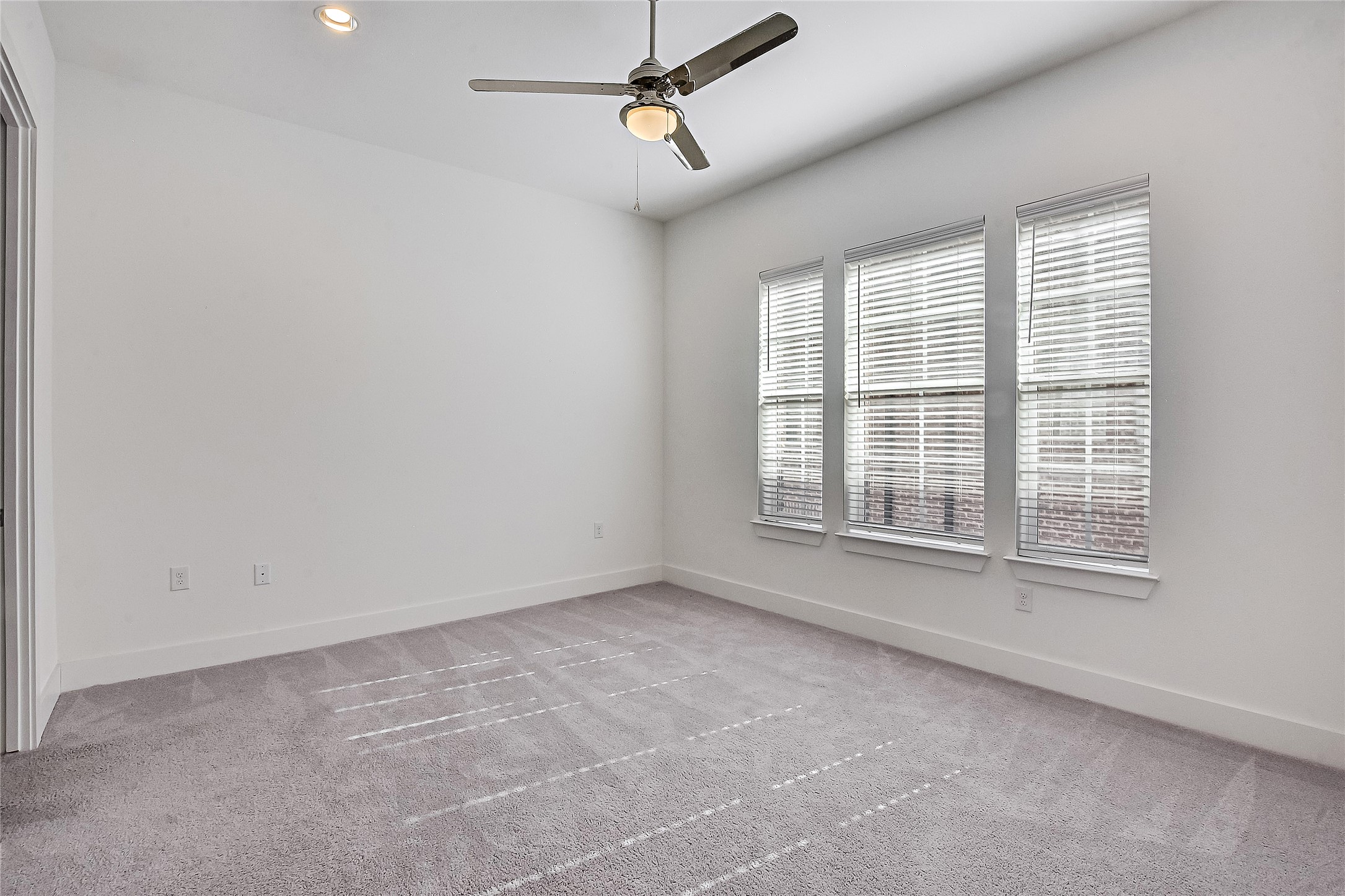 1308 Tinnin Ford Road, Unit 3 Austin, TX 78741 - Photo 16 of 37 Primary Bedroom. High Ceilings with Ceiling fan, recessed lighting and views of the courtyard