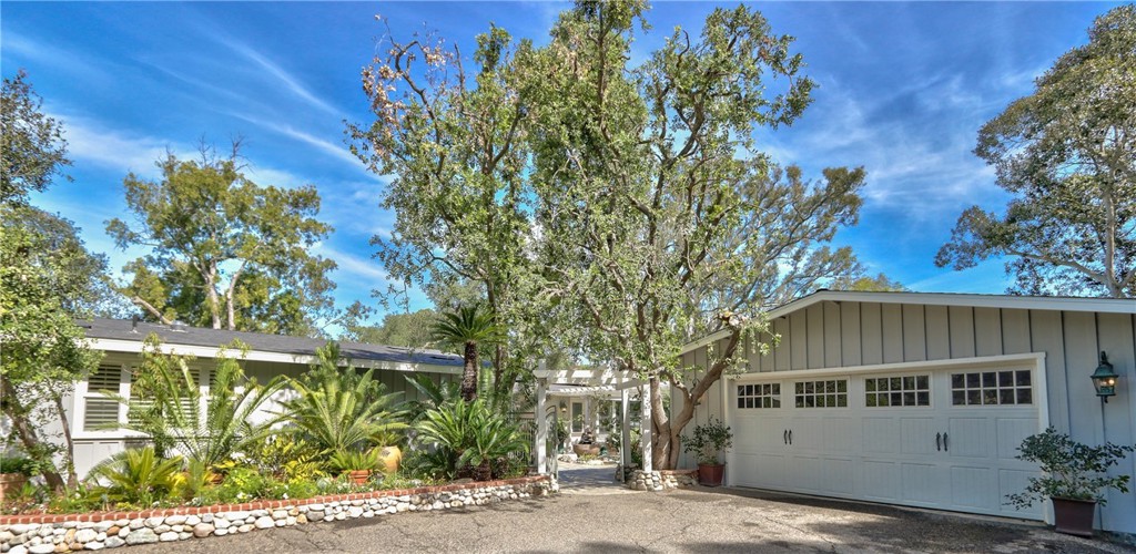 a front view of a house with a garden