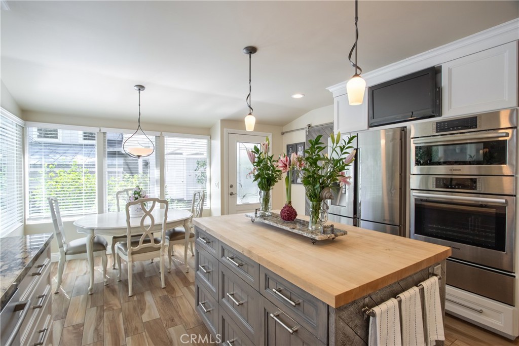 1175 Riverview Drive Fallbrook, CA 92028 - Photo 18 of 57 a kitchen with kitchen island a large counter top space a sink appliances and living room view