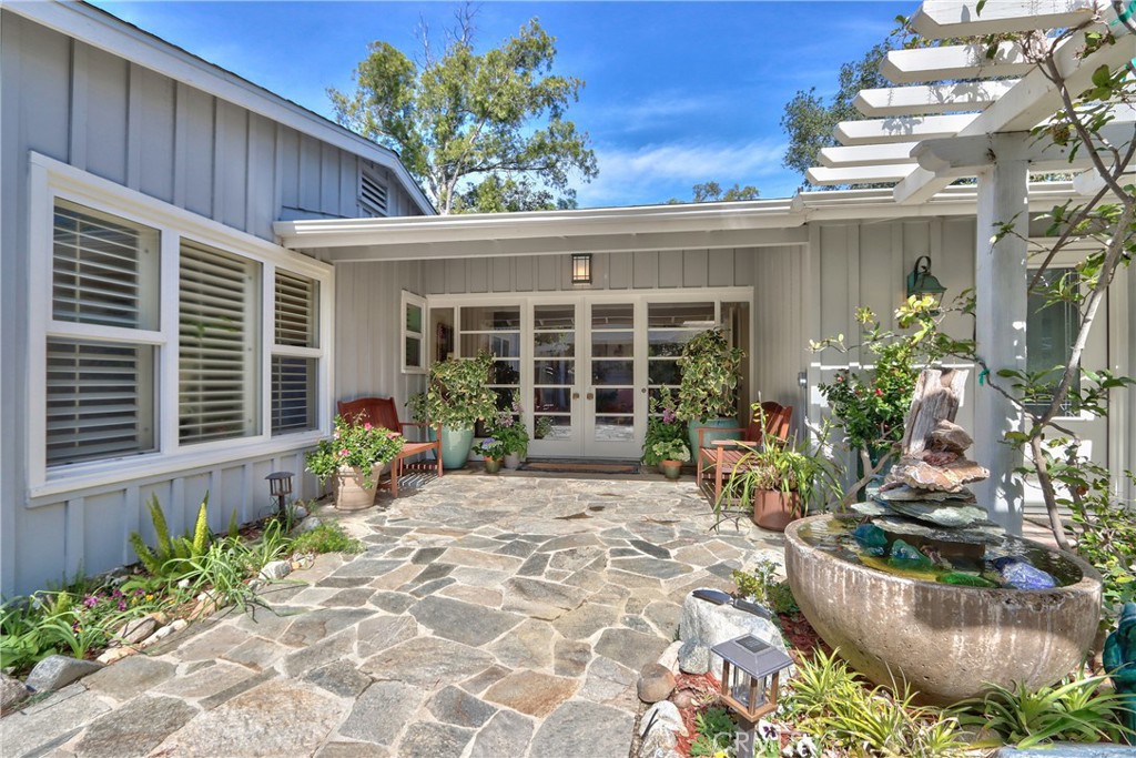 1175 Riverview Drive Fallbrook, CA 92028 - Photo 7 of 57 a front view of a house with a large window and potted plants