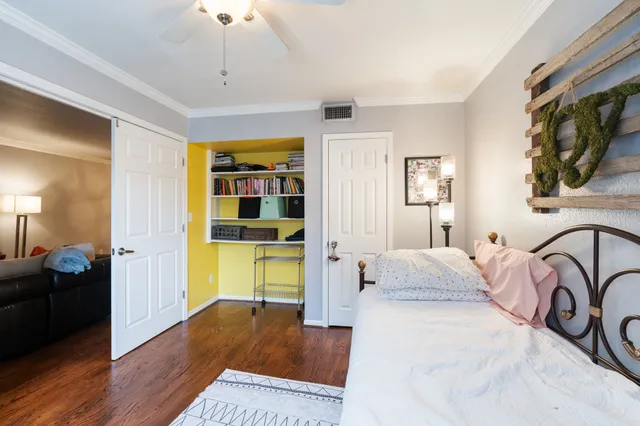 a bedroom with a bed and wooden floor