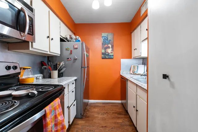 a kitchen with stainless steel appliances granite countertop a stove and a refrigerator