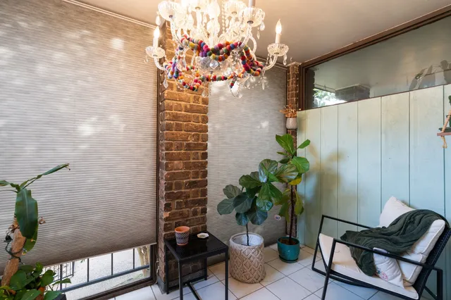 a dining room with furniture and a potted plant