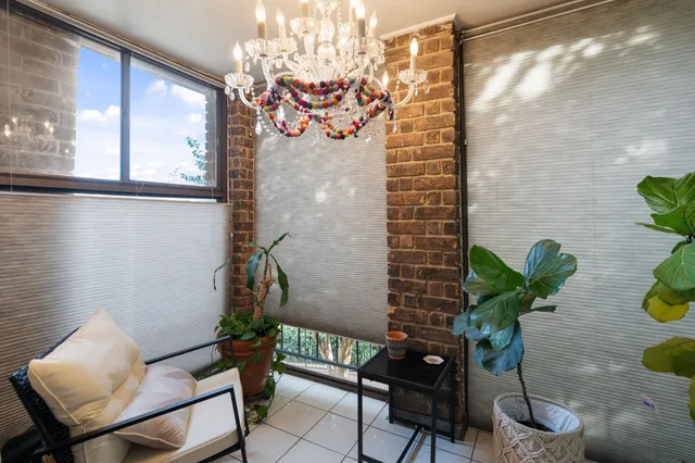 a vase of flowers sitting on a table with wooden floor