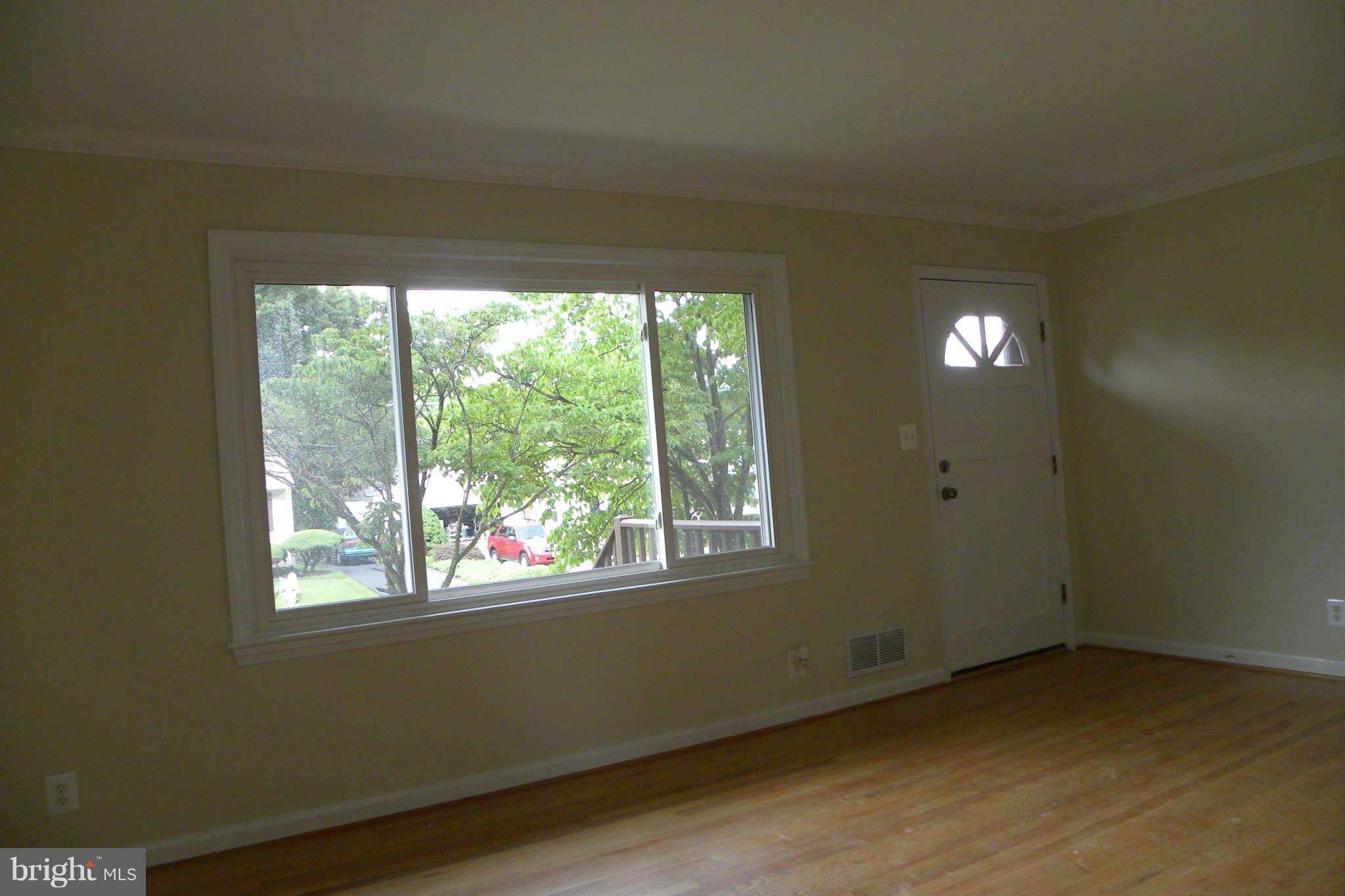 4140 Addison Road Fairfax, VA 22030 - Photo 4 of 27 a view of an empty room with wooden floor and a window