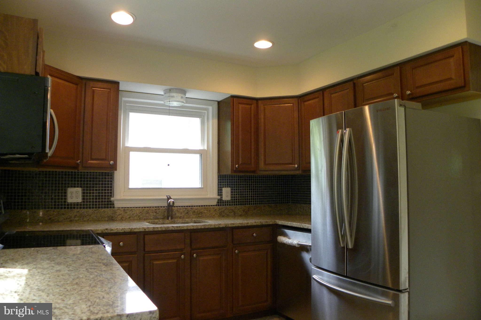 4140 Addison Road Fairfax, VA 22030 - Photo 6 of 27 a kitchen with granite countertop a refrigerator and a sink