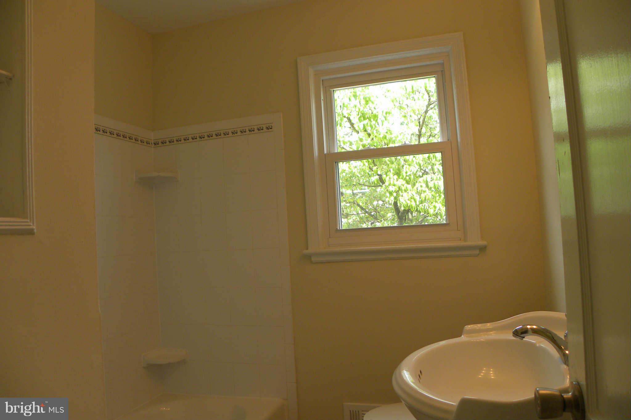 4140 Addison Road Fairfax, VA 22030 - Photo 10 of 27 a bathroom with a sink a window and a toilet