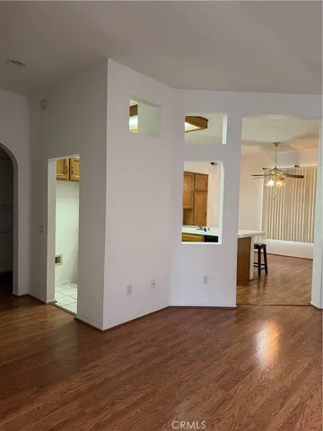 a view of a livingroom with wooden floor and a window