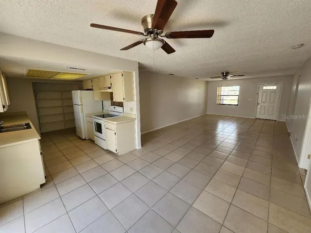 a view of a refrigerator and window in a room