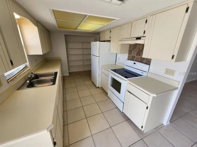 a kitchen with a stove and a refrigerator