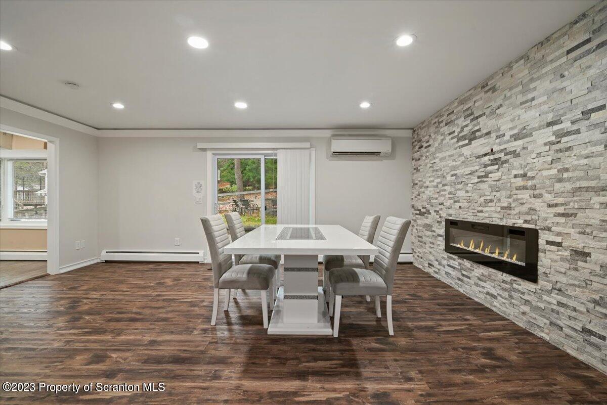 110 Chipmunk Drive Tafton, PA 18464 - Photo 13 of 60 a dining room with furniture a fireplace and wooden floor