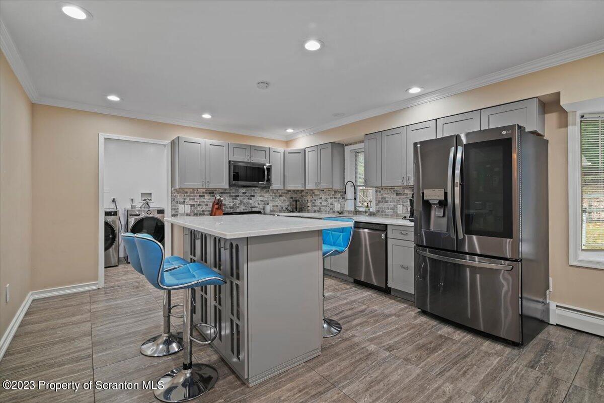 110 Chipmunk Drive Tafton, PA 18464 - Photo 16 of 60 a kitchen with stainless steel appliances a refrigerator a stove a sink a dining table and chairs