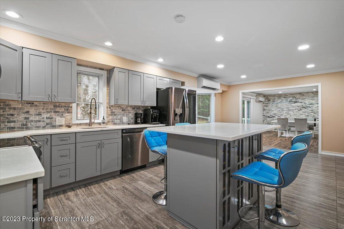 110 Chipmunk Drive Tafton, PA 18464 - Photo 17 of 60 a kitchen with kitchen island a dining table chairs stainless steel appliances and cabinets