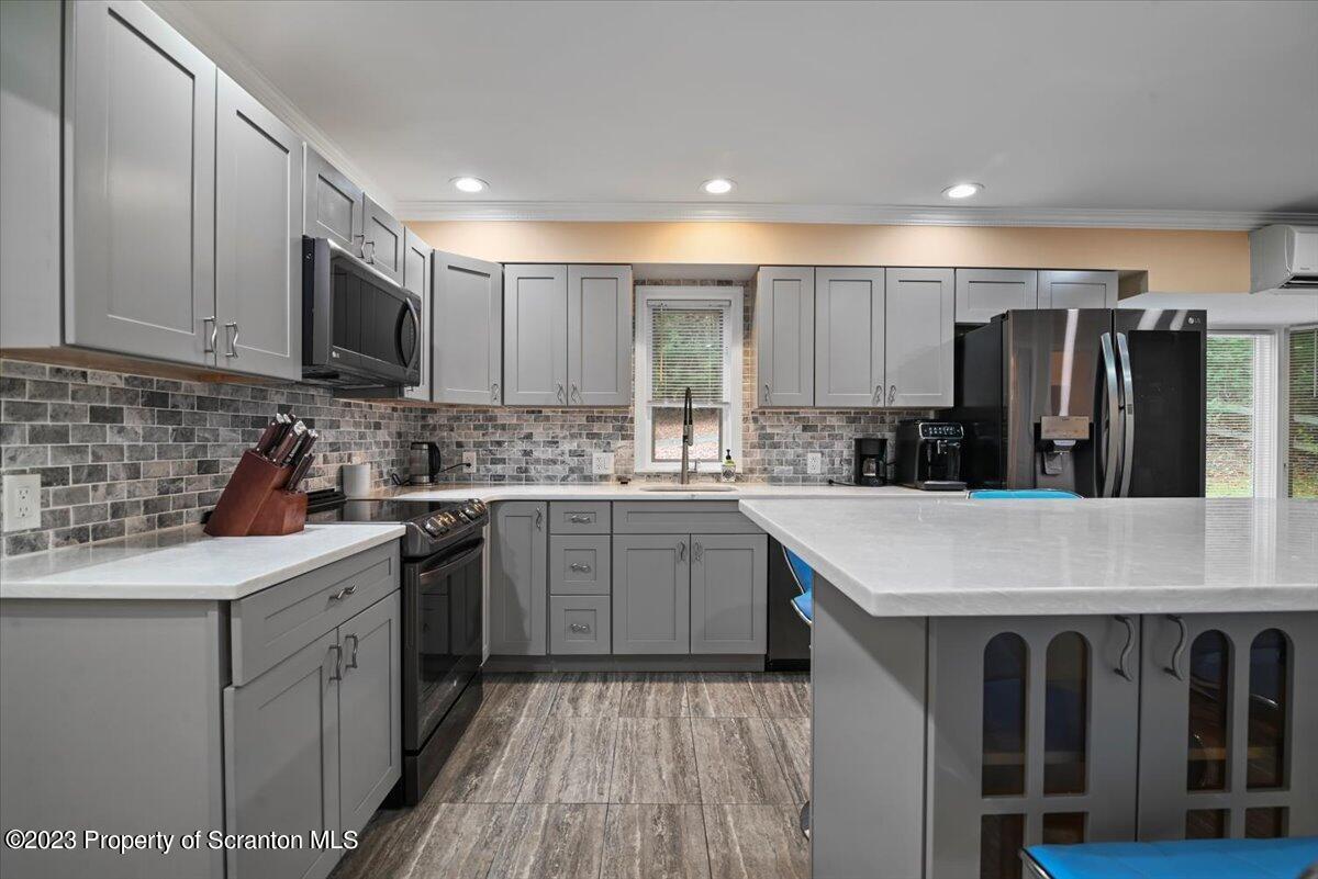 110 Chipmunk Drive Tafton, PA 18464 - Photo 18 of 60 a kitchen with stainless steel appliances granite countertop a sink stove and refrigerator
