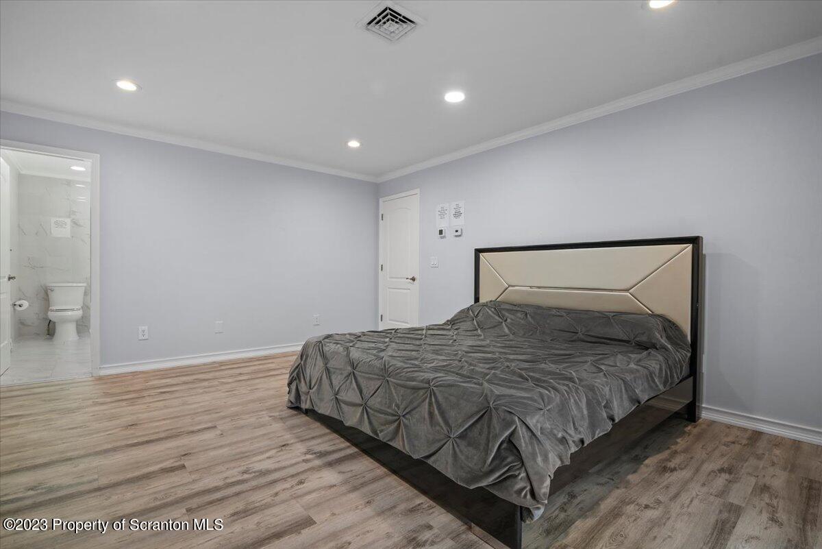 110 Chipmunk Drive Tafton, PA 18464 - Photo 25 of 60 a bedroom with a bed and wooden floor