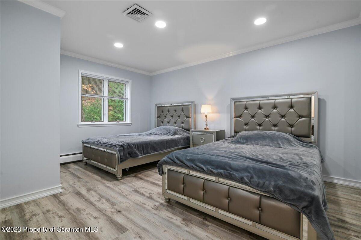 110 Chipmunk Drive Tafton, PA 18464 - Photo 30 of 60 a bedroom with a bed and wooden floor