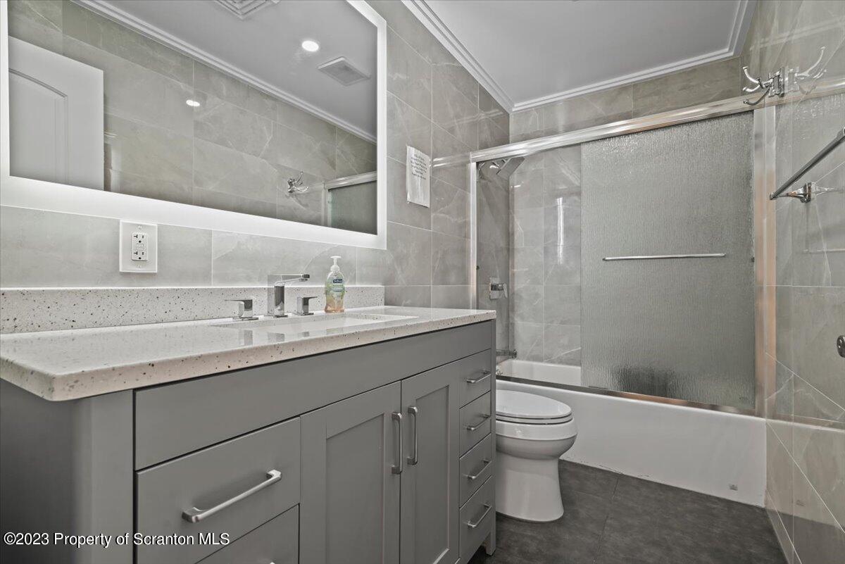 110 Chipmunk Drive Tafton, PA 18464 - Photo 34 of 60 a bathroom with a shower sink vanity mirror and toilet