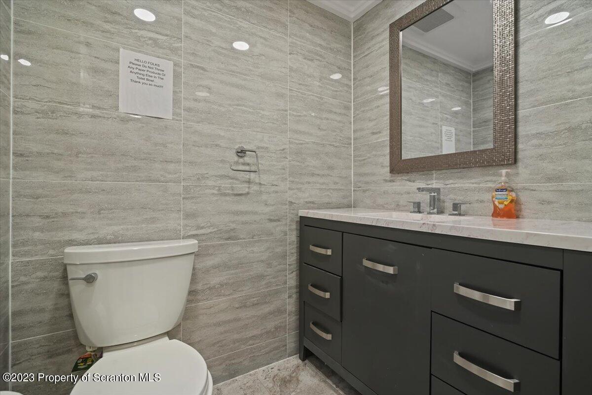 110 Chipmunk Drive Tafton, PA 18464 - Photo 45 of 60 a bathroom with a toilet a sink and mirror