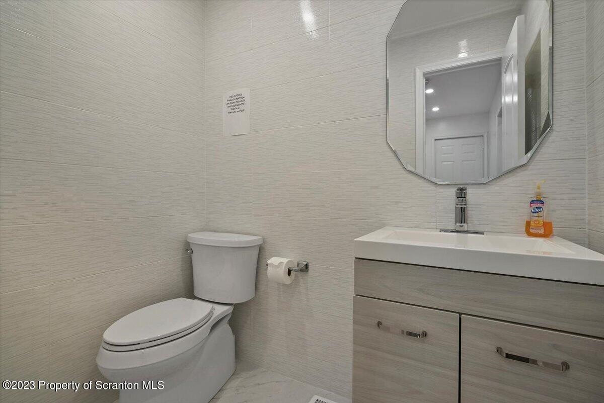 110 Chipmunk Drive Tafton, PA 18464 - Photo 46 of 60 a bathroom with a toilet a sink and mirror