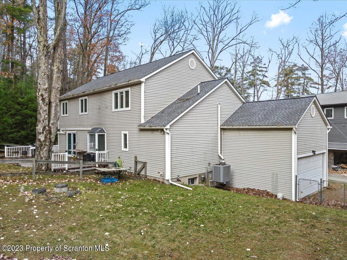 110 Chipmunk Drive Tafton, PA 18464 - Photo 56 of 60 a view of a white house with a yard and lawn chairs with wooden fence