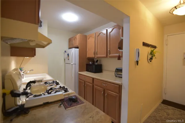 a kitchen with a refrigerator and a stove