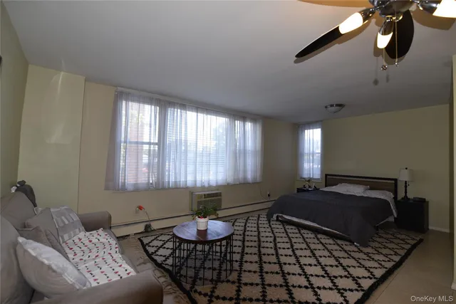 a bedroom with furniture and a window