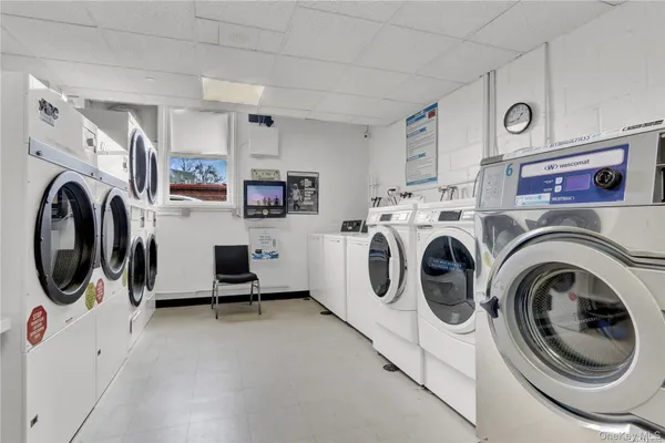 a view of a storage and utility room with washer and dryer