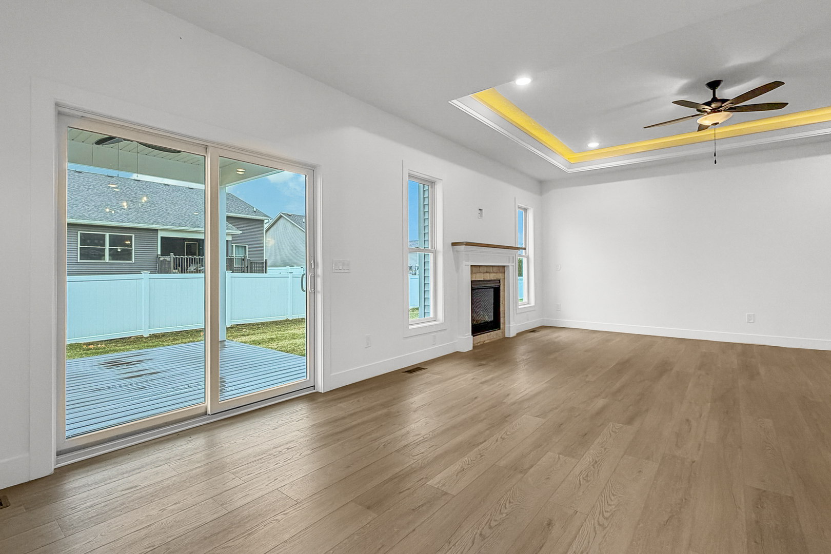 606 Kevin Road Blue Grass, IA 52726 - Photo 25 of 33 an empty room with wooden floor and a fireplace