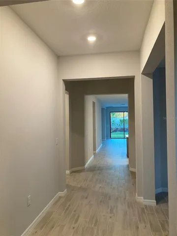 a view of a room with wooden floor and a window