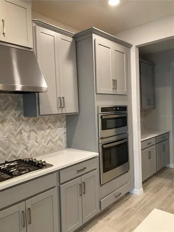 a kitchen with granite countertop a stove and a sink