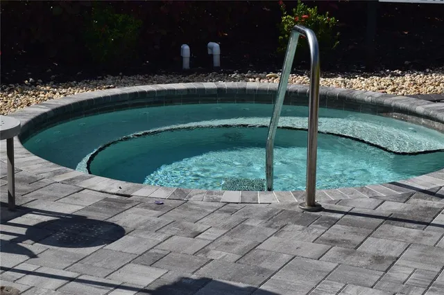 a backyard of a house with lots of green space and fountain