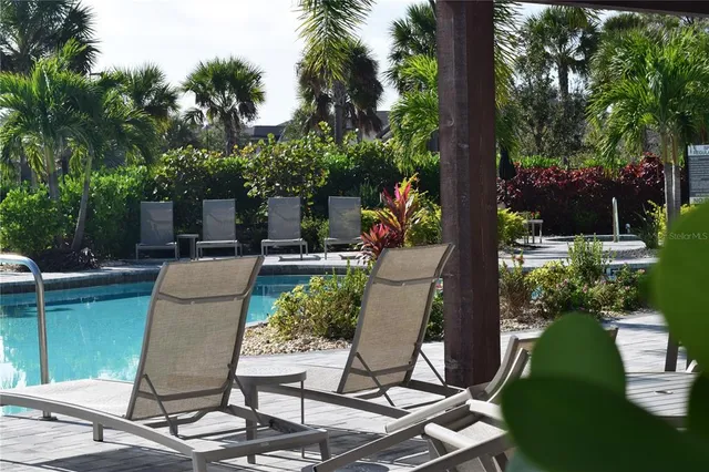a view of a patio with table and chairs potted plants and large tree