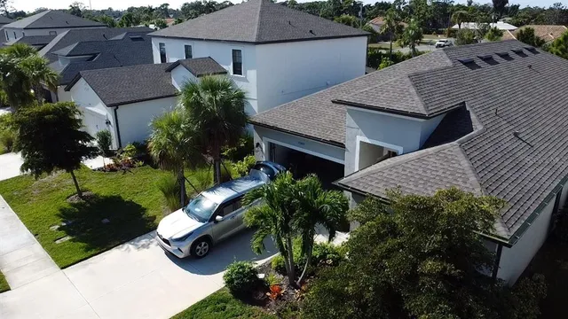 an aerial view of a house with yard and outdoor seating