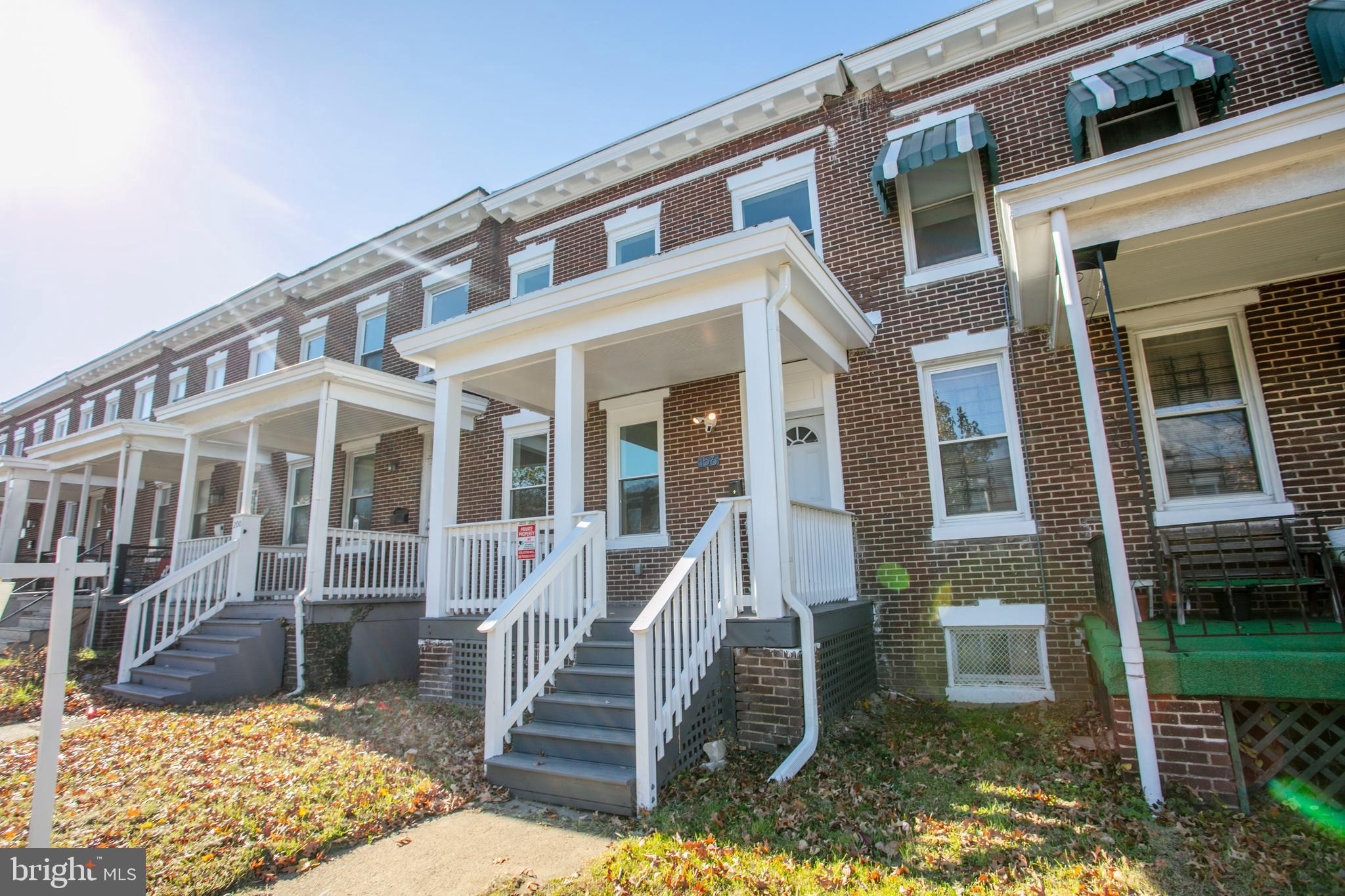 156 South Hilton Street Baltimore, MD 21229 - Photo 2 of 39 a front view of a house with a yard