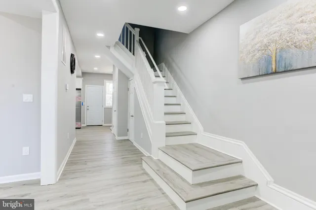 a view of entryway and hall with wooden floor