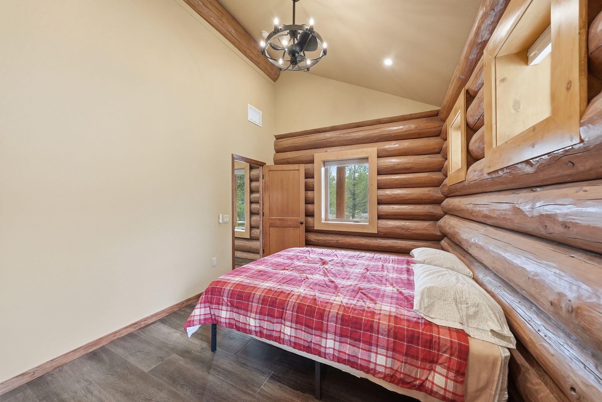 54270 Huntington Road La Pine, OR 97739 - Photo 15 of 68 a bedroom with a bed window and a chandelier