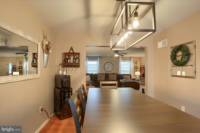 a view of a livingroom with furniture and hardwood floor