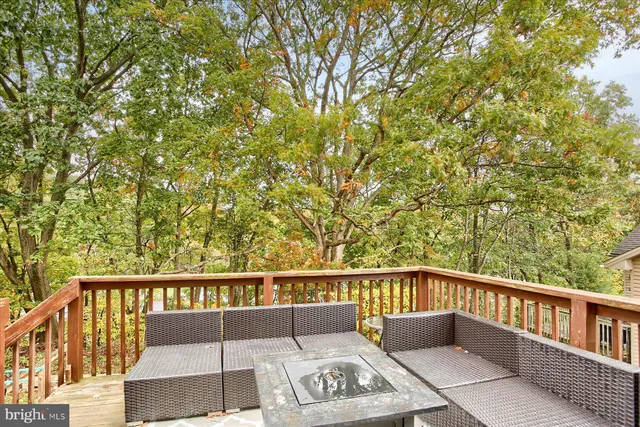 a view of a balcony with wooden floor and fence