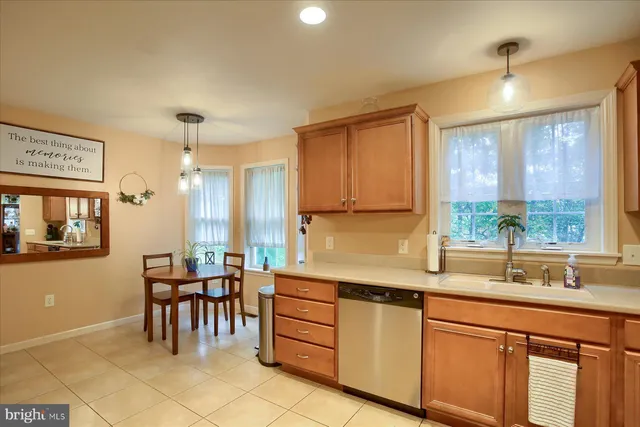 a kitchen with granite countertop a sink cabinets and stainless steel appliances