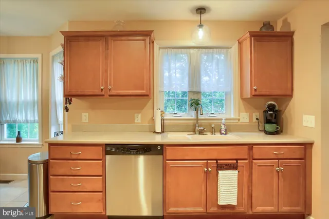 a kitchen with stainless steel appliances granite countertop a sink and a window