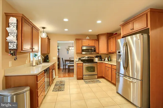 a kitchen with stainless steel appliances refrigerator stove microwave and cabinets