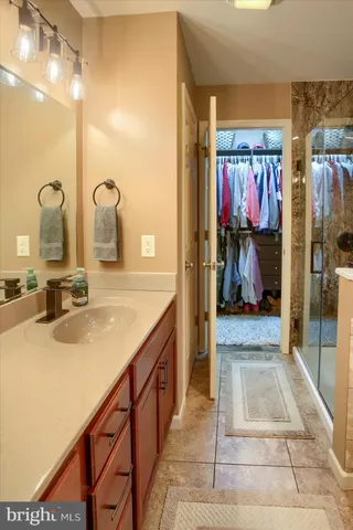 a bathroom with a tub sink and mirror