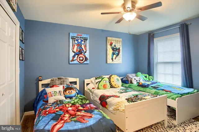 a bedroom with two beds and a window